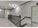 Hallway features wood floors, neutral paint, and decorative railing with access to multiple rooms at 4208 Sierra Creek Ct, Hoschton, GA 30548