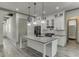 Modern kitchen with white cabinets, gray countertops, stainless steel appliances, and island at 4208 Sierra Creek Ct, Hoschton, GA 30548