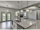 Kitchen island featuring a sink and dishwasher with stainless appliances and quartz countertops at 4208 Sierra Creek Ct, Hoschton, GA 30548