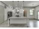 Modern kitchen featuring island with sink, stainless appliances, and pantry at 4208 Sierra Creek Ct, Hoschton, GA 30548