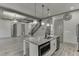 Open concept floor plan featuring a kitchen island, stainless appliances, and staircase at 4208 Sierra Creek Ct, Hoschton, GA 30548