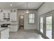 Modern kitchen featuring stainless appliances, quartz countertops, and walk in pantry at 4208 Sierra Creek Ct, Hoschton, GA 30548
