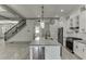 Open concept kitchen with stainless steel appliances, white cabinets, and access to the deck at 4208 Sierra Creek Ct, Hoschton, GA 30548