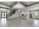 Spacious living room with staircase, wood floors, and open floor plan to kitchen at 4208 Sierra Creek Ct, Hoschton, GA 30548