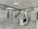 Open floor plan with a view from the kitchen to the living room and staircase with coffered ceilings at 4208 Sierra Creek Ct, Hoschton, GA 30548