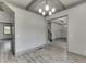 View of living room and dining area with hardwood floors and stylish lighting fixtures at 4208 Sierra Creek Ct, Hoschton, GA 30548