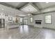 Open concept living room and kitchen with white cabinets, stone countertops, and stainless appliances at 4208 Sierra Creek Ct, Hoschton, GA 30548