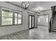 Open-concept living area with hardwood floors, modern lighting, and views of the outdoors at 4208 Sierra Creek Ct, Hoschton, GA 30548