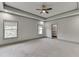 Spacious main bedroom featuring neutral paint, carpet, recessed lighting, and natural light at 4208 Sierra Creek Ct, Hoschton, GA 30548