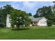 Lovely home exterior with manicured lawn, landscaping, and attached two car garage at 10307 E Cherokee Dr, Canton, GA 30115