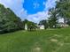 Serene view of a spacious front yard, showcasing the home's inviting curb appeal at 10307 E Cherokee Dr, Canton, GA 30115