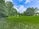 Lush green front yard showcasing the natural beauty surrounding this charming home at 10307 E Cherokee Dr, Canton, GA 30115