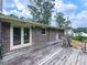 A weathered wooden deck outside a brick house, perfect for outdoor relaxation and entertainment at 10381 E Cherokee Dr, Canton, GA 30115