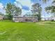 Lush backyard with mature trees surrounding the rear of the home and a serene outdoor space at 10381 E Cherokee Dr, Canton, GA 30115