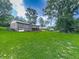 Expansive backyard view highlighting the lush lawn and the back of the brick home at 10381 E Cherokee Dr, Canton, GA 30115