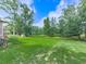 Expansive backyard with lush green grass and mature trees, perfect for outdoor activities and relaxation at 10381 E Cherokee Dr, Canton, GA 30115