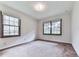 Neutral bedroom featuring carpeted floors, natural light from two windows at 10381 E Cherokee Dr, Canton, GA 30115