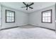 Neutral bedroom with carpeted floors and natural light from two windows at 10381 E Cherokee Dr, Canton, GA 30115