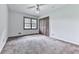 Neutral bedroom featuring carpeted floors, natural light, and closet at 10381 E Cherokee Dr, Canton, GA 30115