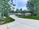Single-story house with a long driveway, a well-maintained lawn, and an attached garage in a wooded area at 10381 E Cherokee Dr, Canton, GA 30115
