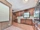Kitchen featuring wood cabinets, laminate countertops, and stainless appliances at 10381 E Cherokee Dr, Canton, GA 30115