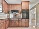 Kitchen featuring wood cabinets, laminate countertops, and built-in oven at 10381 E Cherokee Dr, Canton, GA 30115