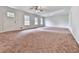 Large living room boasting new paint, neutral carpeting, a ceiling fan, and lots of natural light at 10381 E Cherokee Dr, Canton, GA 30115