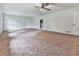 Spacious living room featuring neutral carpet, white walls, and ample natural light from a large window at 10381 E Cherokee Dr, Canton, GA 30115