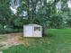 Outdoor storage shed set in a wooded area and offering a practical solution for garden tools at 10381 E Cherokee Dr, Canton, GA 30115