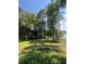 Picturesque backyard with lush greenery, mature trees, and a tranquil view of the lake at 160 Eastlake Nw Pt, Kennesaw, GA 30144