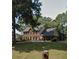 Beautiful brick home with manicured lawn, mature trees, and classic architectural details enhancing curb appeal at 160 Eastlake Nw Pt, Kennesaw, GA 30144