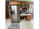 Kitchen features an island, built-in desk, refrigerator, and cabinet at 160 Eastlake Nw Pt, Kennesaw, GA 30144