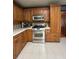 Close up of stainless steel oven and cooktop in kitchen with tile floors at 160 Eastlake Nw Pt, Kennesaw, GA 30144