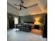 Spacious main bedroom with a tray ceiling, neutral carpet, and a cozy bed, offering a relaxing retreat at 160 Eastlake Nw Pt, Kennesaw, GA 30144