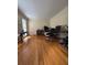 A well-lit office space with hardwood flooring, a functional desk setup, and ample natural light for a productive work environment at 160 Eastlake Nw Pt, Kennesaw, GA 30144