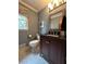 Well lit powder room with updated vanity, patterned floor and modern mirror at 160 Eastlake Nw Pt, Kennesaw, GA 30144