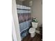 Simple bathroom with a patterned shower curtain, toilet, and storage at 22 Fairview Dr, Jonesboro, GA 30238