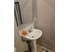 Close-up of a pedestal sink in a bathroom with neutral walls and a mirror at 22 Fairview Dr, Jonesboro, GA 30238