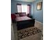Stylish bedroom with blue walls, a dark bed frame, and a patterned rug at 22 Fairview Dr, Jonesboro, GA 30238