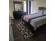 Cozy bedroom with a large window, dresser, and comfortable bed, creating a peaceful retreat at 22 Fairview Dr, Jonesboro, GA 30238