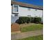 Charming townhome with manicured front yard and gray siding, complemented by a quaint wooden fence at 22 Fairview Dr, Jonesboro, GA 30238
