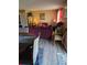 Cozy living area with warm hardwood floors, a burgundy sofa, and tasteful decor at 22 Fairview Dr, Jonesboro, GA 30238