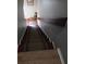 Carpeted stairs with painted walls lead to the lower level at 22 Fairview Dr, Jonesboro, GA 30238