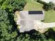 Overhead view of a house with solar panels, surrounded by lush trees and greenery at 235 Pirkle Ct, Cumming, GA 30040