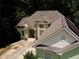 An overhead view of a well-maintained home with a pristine roof and inviting front yard at 235 Pirkle Ct, Cumming, GA 30040