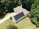 Aerial view of a home with a solar panel system, surrounded by lush greenery at 235 Pirkle Ct, Cumming, GA 30040