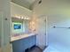 Bright bathroom featuring a double vanity with marble countertop and a large mirror and updated fixtures at 235 Pirkle Ct, Cumming, GA 30040