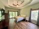 A bedroom featuring a trey ceiling, a ceiling fan, and multiple windows at 235 Pirkle Ct, Cumming, GA 30040