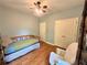 Comfortable bedroom with wood floors, a daybed and a large closet and sitting chair at 235 Pirkle Ct, Cumming, GA 30040