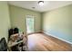 Simple bedroom featuring hardwood floors, a single window, and neutral paint at 235 Pirkle Ct, Cumming, GA 30040